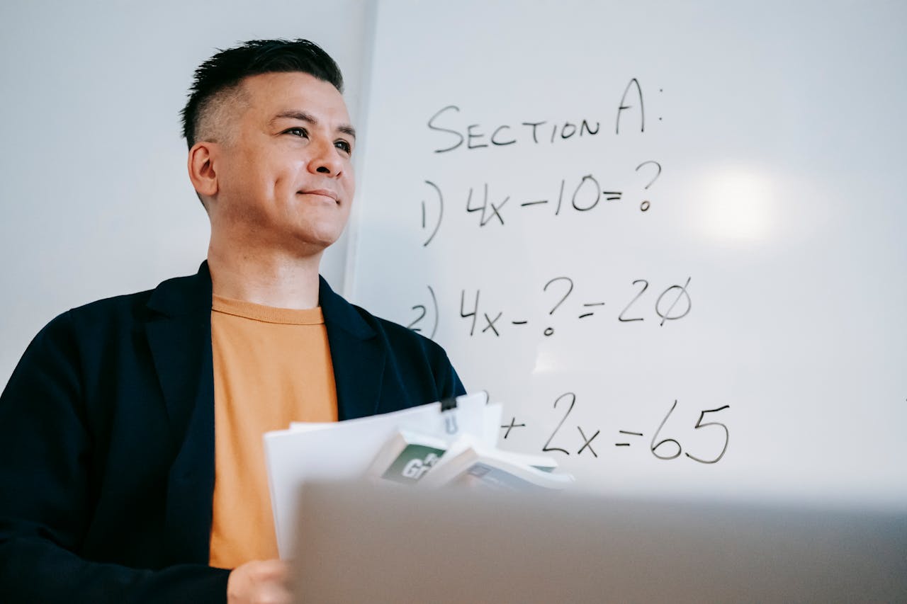 Photo Of Man Holding Paperworks